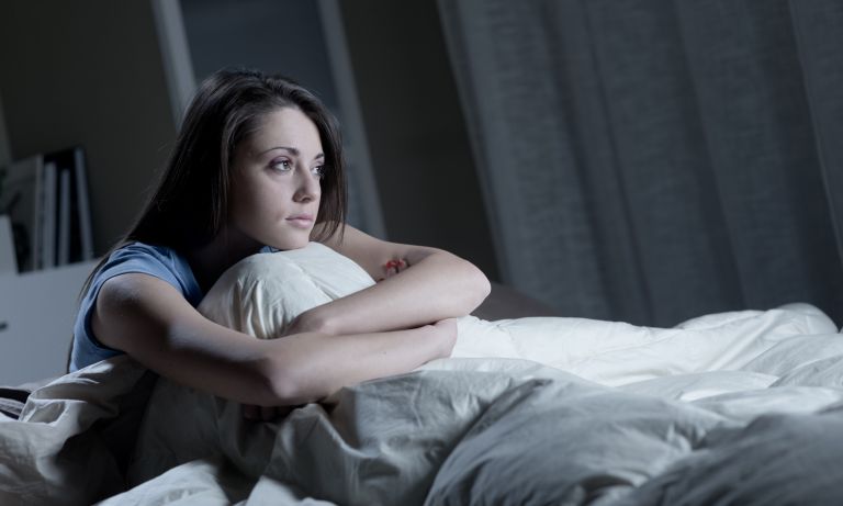 woman staring out from bed 768